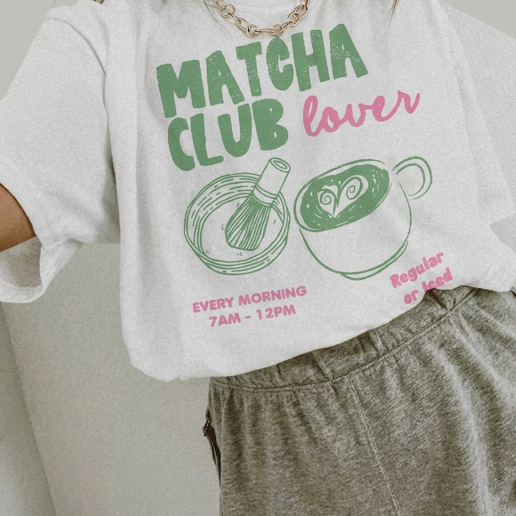 Person in "Matcha Club Lover" tee with matcha illustrations. Casual and chic style.