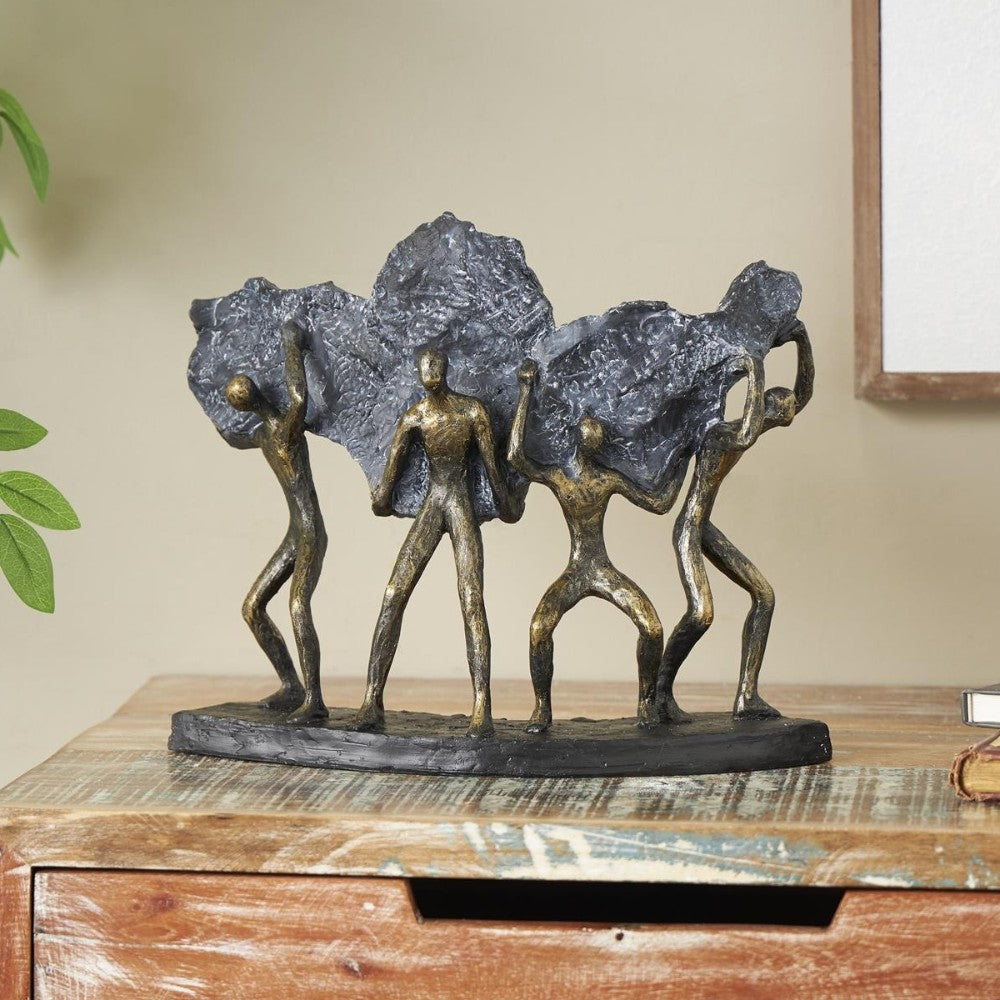 Bronze figures holding textured rock forms on a wooden table.