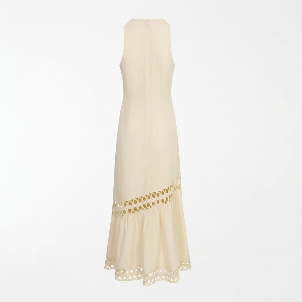Long beige dress with cutout details at the hem.