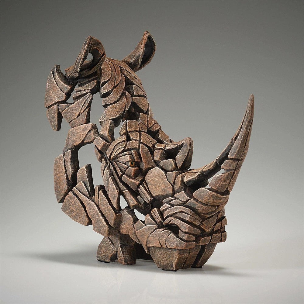 Abstract rhino sculpture made of fragmented stone-like pieces.