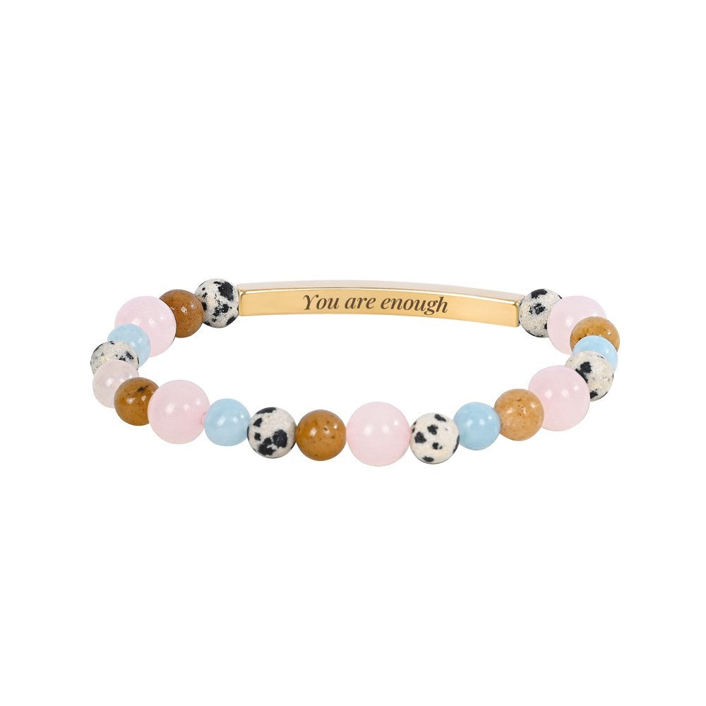 Colorful beaded bracelet with "You are enough" engraved on a gold bar.