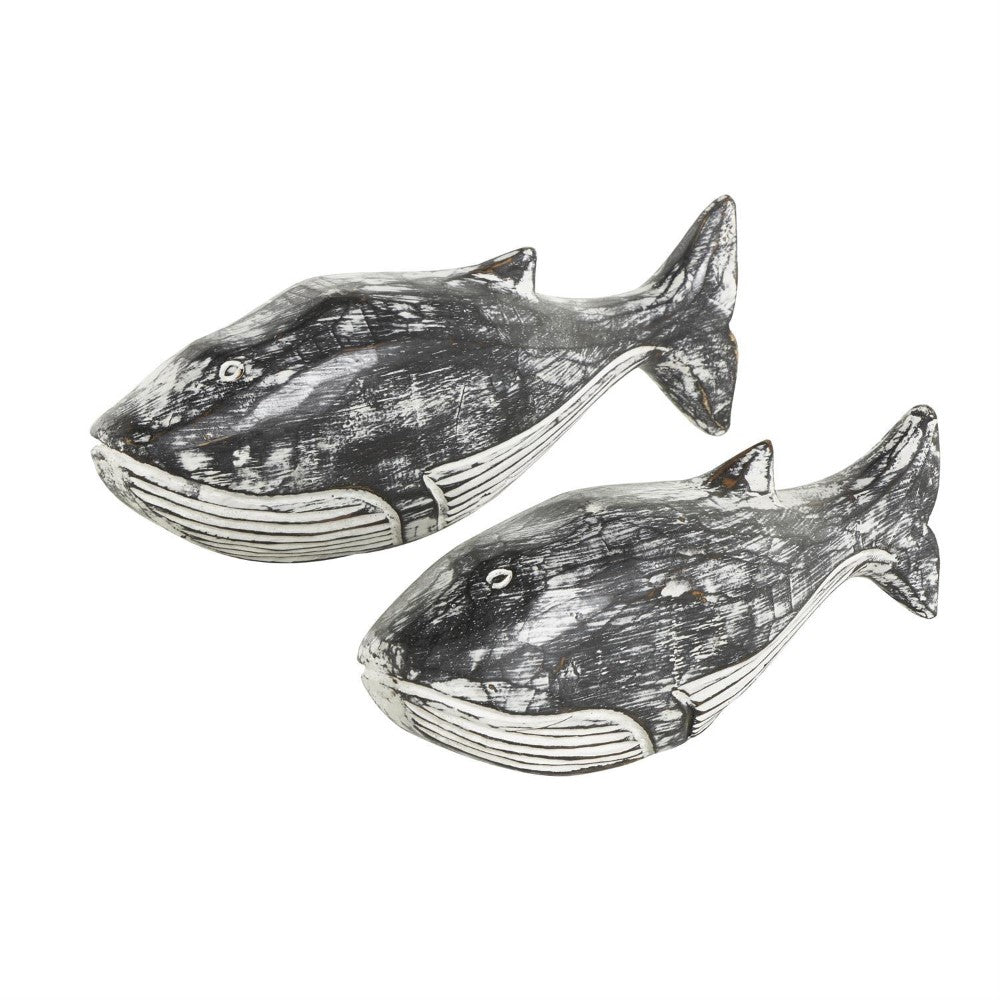 Two carved wooden whale figures with a rustic finish.