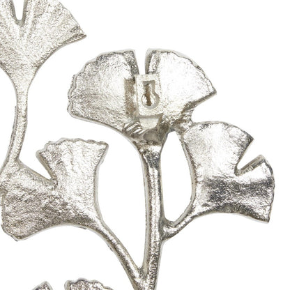Silver metallic leaf-shaped decor piece.