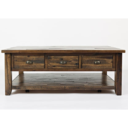 Rustic wooden coffee table with drawers and shelf.
