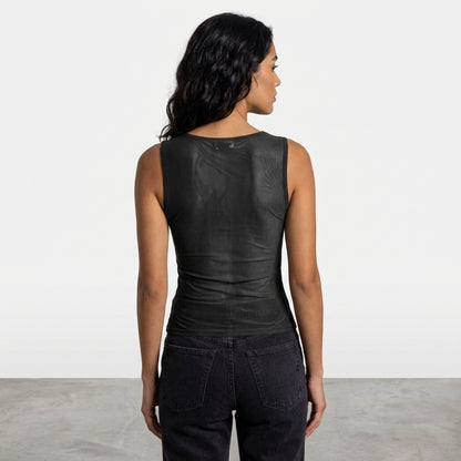 Person in black sleeveless top and jeans, facing away.