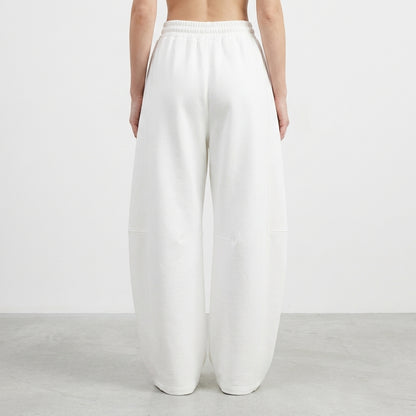 Person wearing loose white pants, back view.