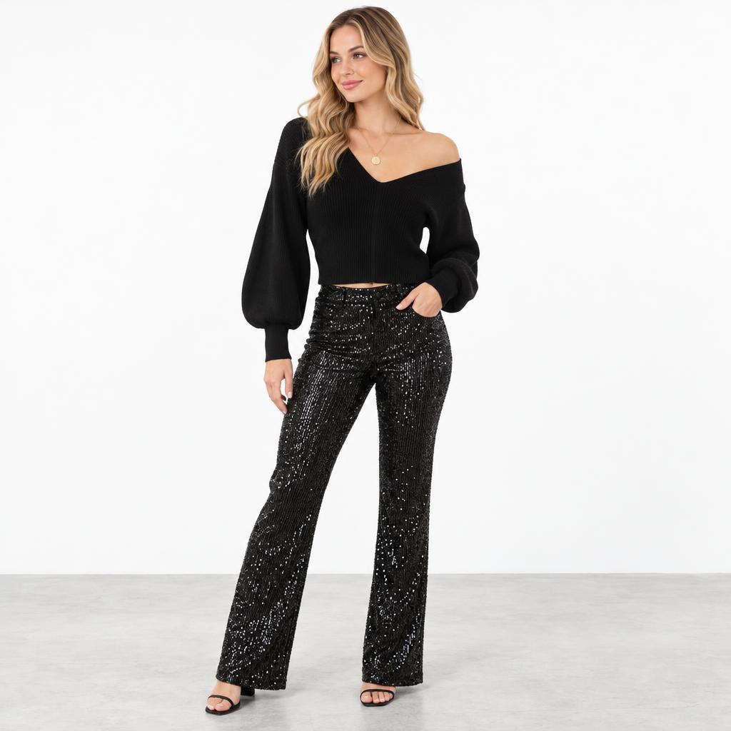 A woman models a black off-shoulder sweater and sparkling wide-leg pants against a white background.