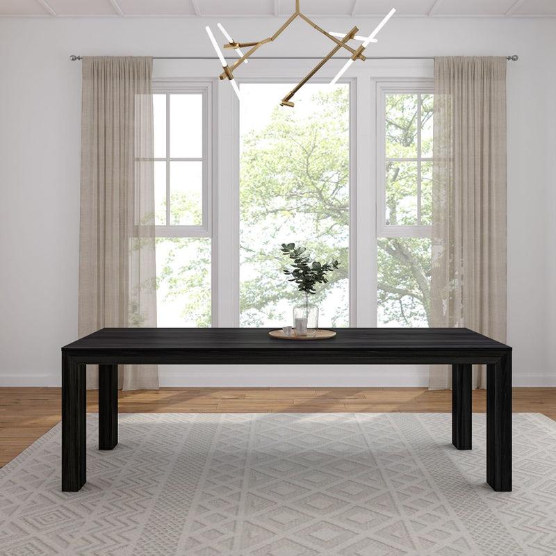 Minimalist dining room with a dark table, modern light, and large window views.