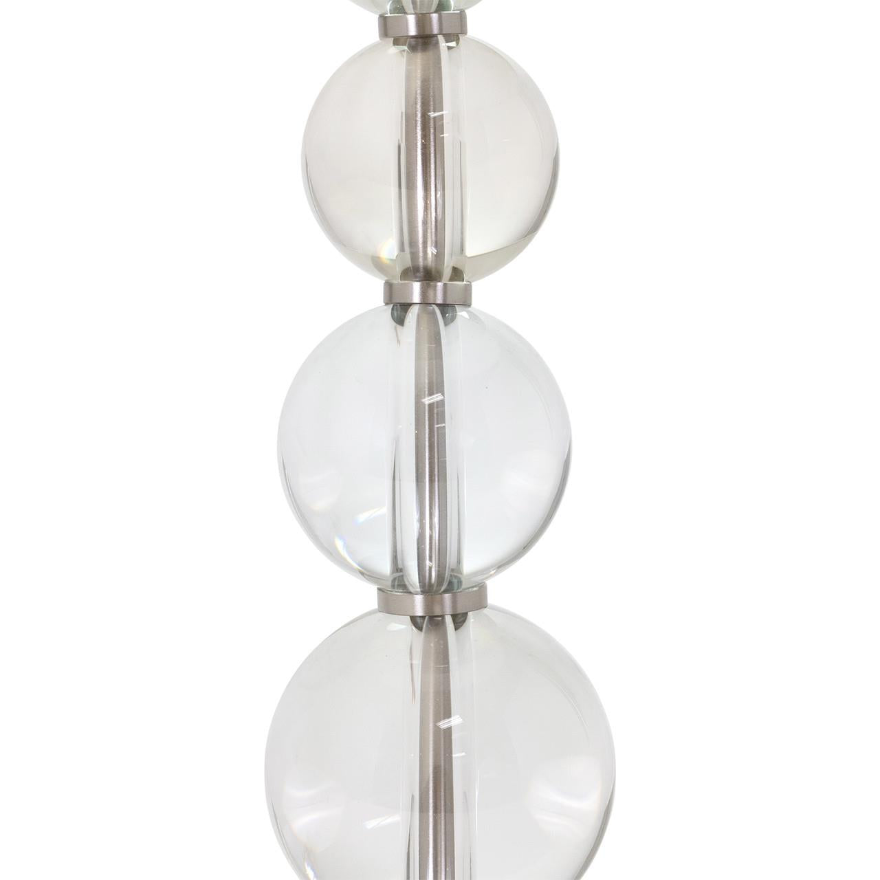 Glass spheres stacked with metallic separators in a vertical arrangement.