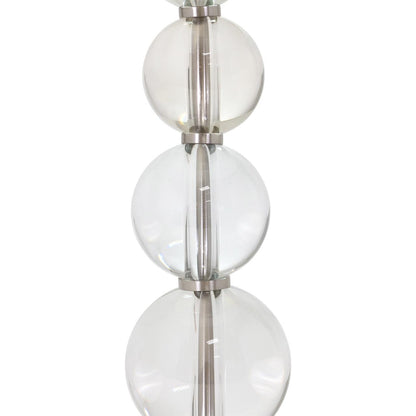 Glass spheres stacked with metallic separators in a vertical arrangement.