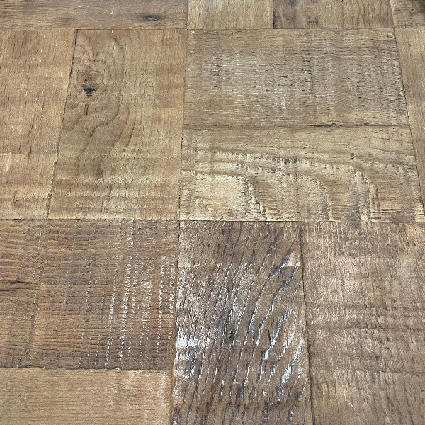 Close-up of a wooden parquet floor with varied textures.