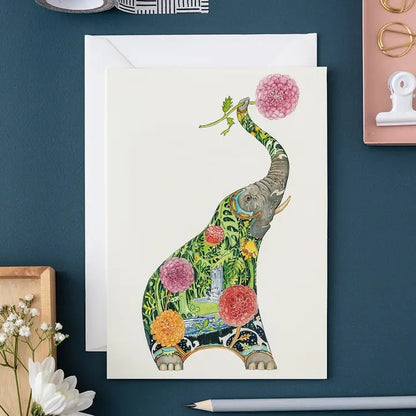 Artistic elephant card with vibrant floral design on dark blue background.