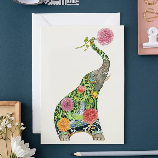 Artistic elephant card with vibrant floral design on dark blue background.