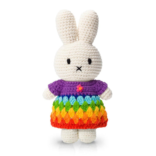 Crocheted bunny in a rainbow dress with a purple top.