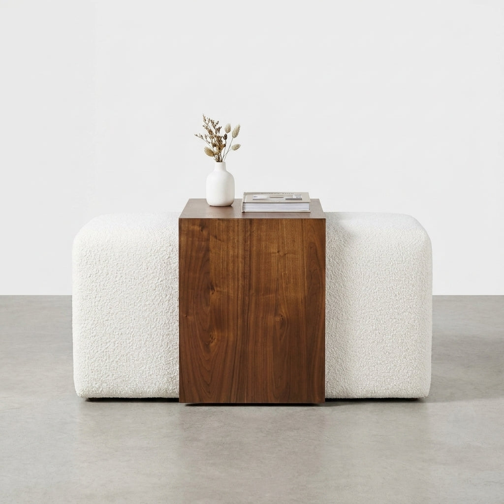 Rectangular wood panel on white textured cushions.