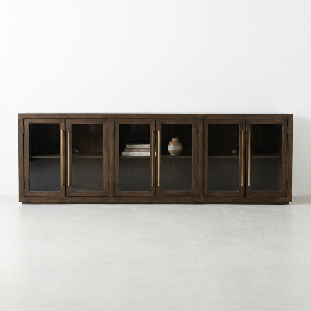 Dark wood cabinet with four glass doors and brass handles.