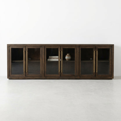 Dark wood cabinet with four glass doors and brass handles.