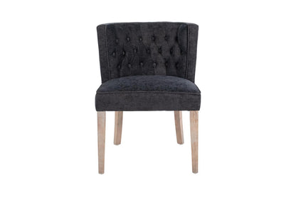 Dark grey tufted chair with light wooden legs.