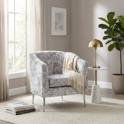 Gray speckled armchair with metal legs.