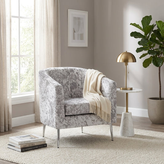 Gray speckled armchair with metal legs.