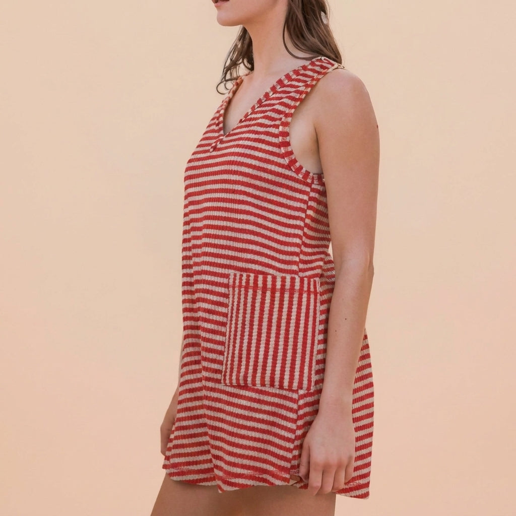 Person in a red and white striped sleeveless dress.