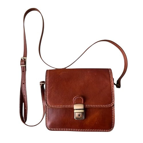 Brown leather crossbody bag with a buckle clasp and adjustable strap.