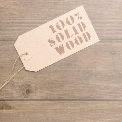 Label reading "100% Solid Wood" on a wooden surface.