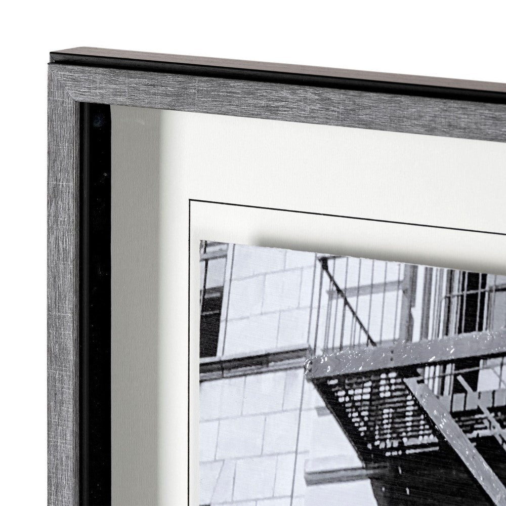 Close-up of a framed black and white photo with a modern gray frame.