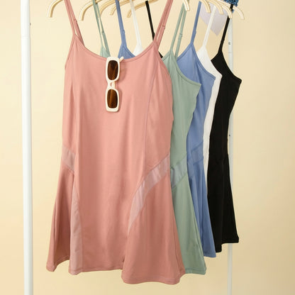 Four colorful dresses hanging on a rack with sunglasses.