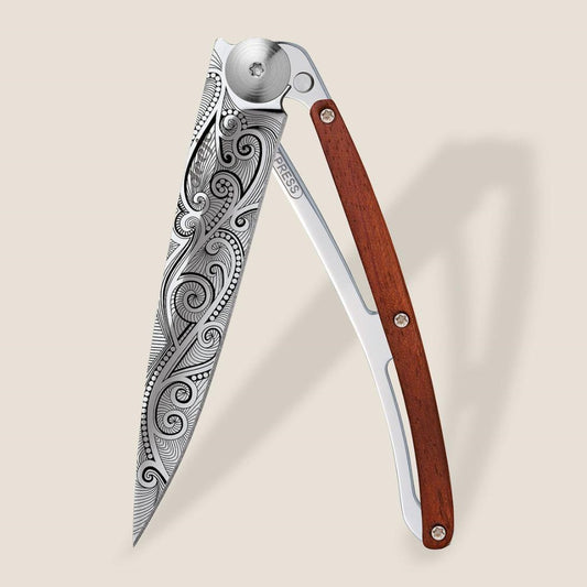 Ornate knife with engraved blade and wooden handle.