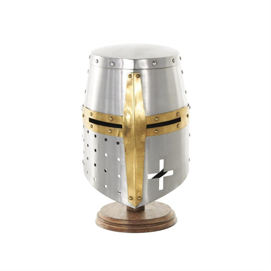 Medieval helmet with brass cross design on wooden base.