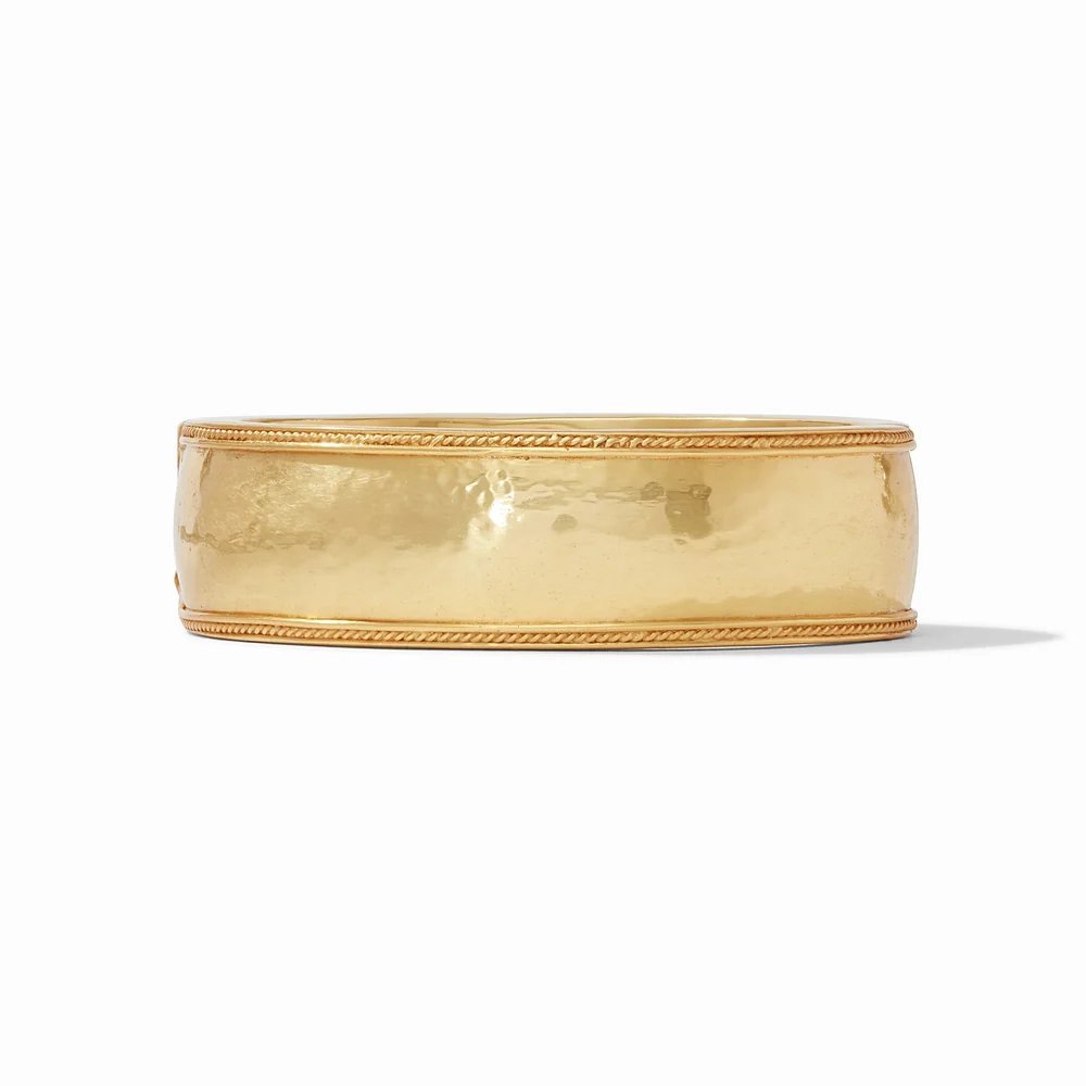A wide gold bangle with a hammered finish and twisted rope trim.
