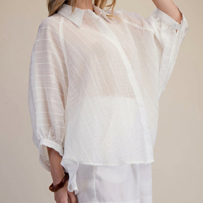 Sheer white blouse with subtle stripes.