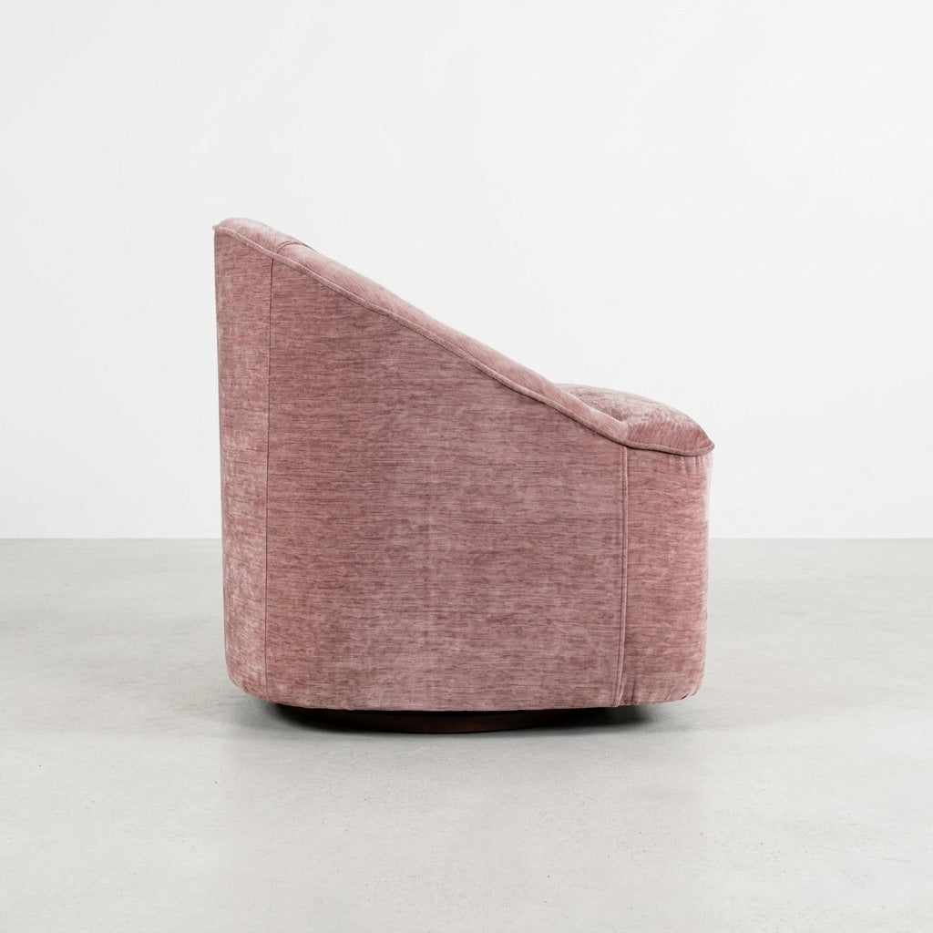 Pink, plush, armless chair with curved back.
