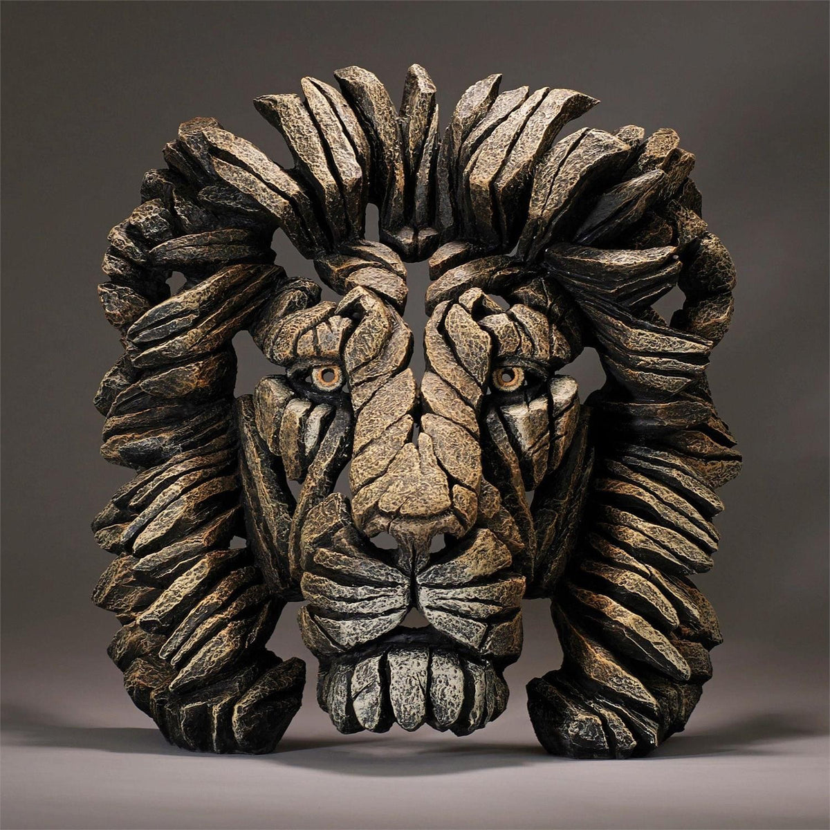 Sculpted lion face made from jagged, textured stone pieces.
