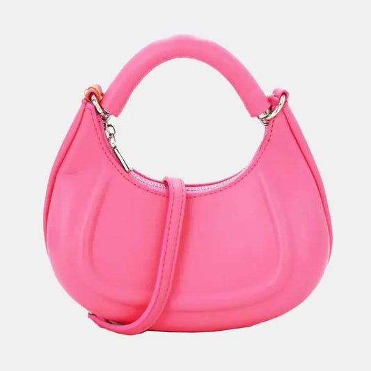 Pink crescent-shaped handbag with a short handle and detachable strap.