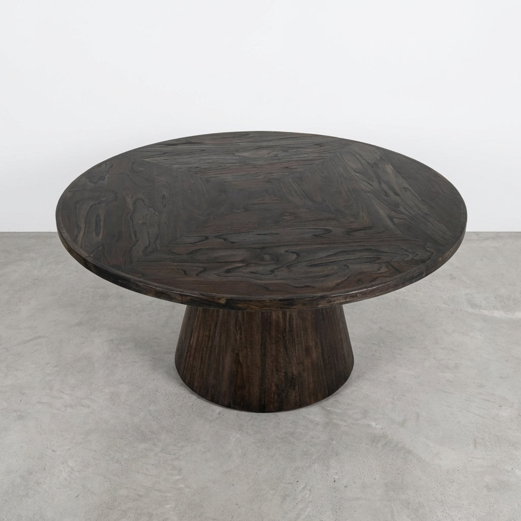Round wooden table with a dark finish and a tapered base.
