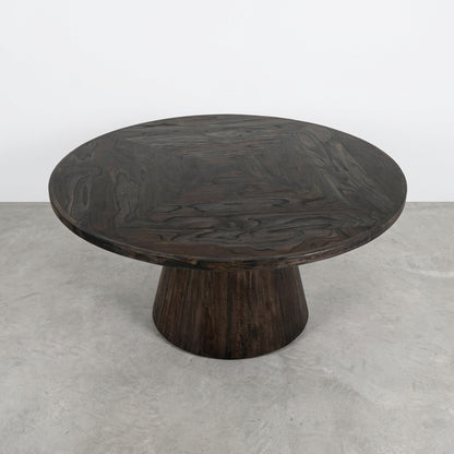 Round wooden table with a dark finish and a tapered base.