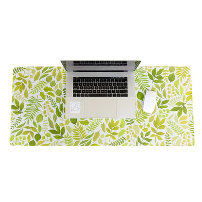Laptop and mouse on a leafy-patterned desk mat.
