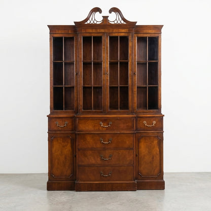 Elegant vintage wooden cabinet with glass doors and drawers.