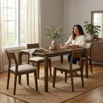 Woman sitting at a dining table, ready for a meal.