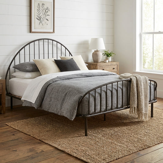 Black metal bed frame with curved headboard and slatted wooden base.