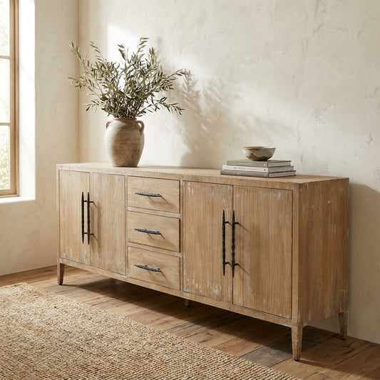 Rustic wooden sideboard with vase and books.