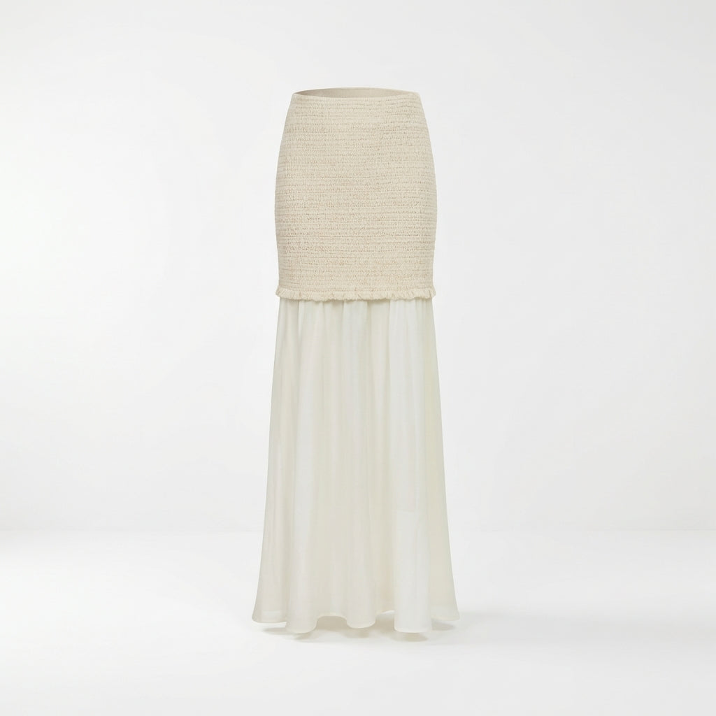 Long ivory skirt with knit texture on top, flowing chiffon below.