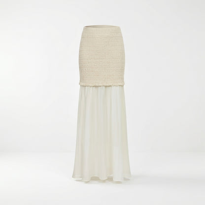 Long ivory skirt with knit texture on top, flowing chiffon below.