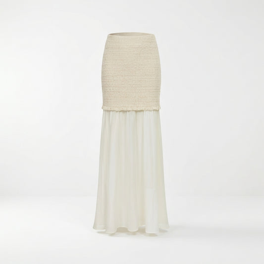 Long ivory skirt with knit texture on top, flowing chiffon below.