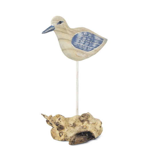 Wooden bird sculpture on driftwood base, blue wings.