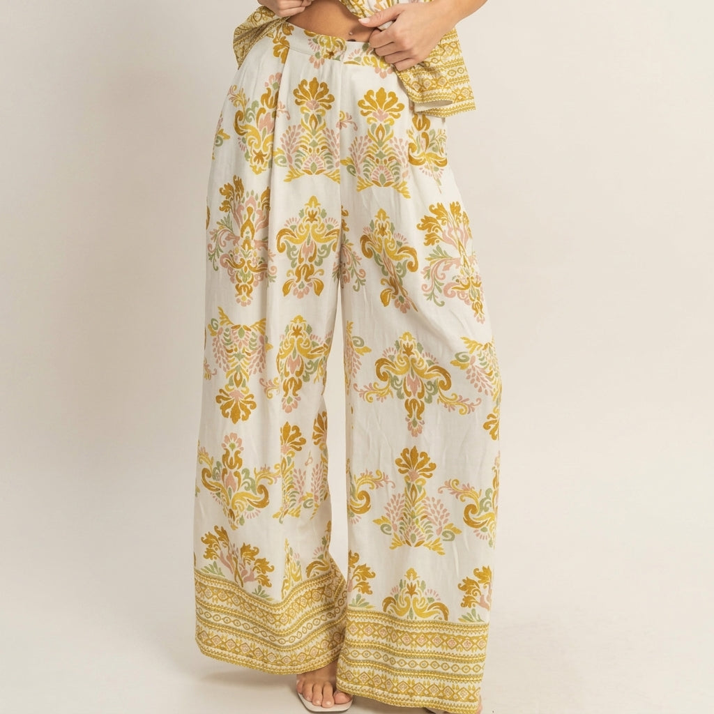Wide-legged pants with ornate yellow floral patterns.
