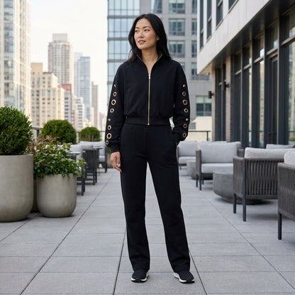 Woman in stylish black outfit on city terrace.