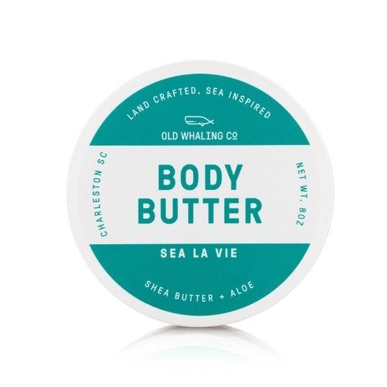 Round body butter container with teal label, "Sea La Vie," shea butter and aloe.